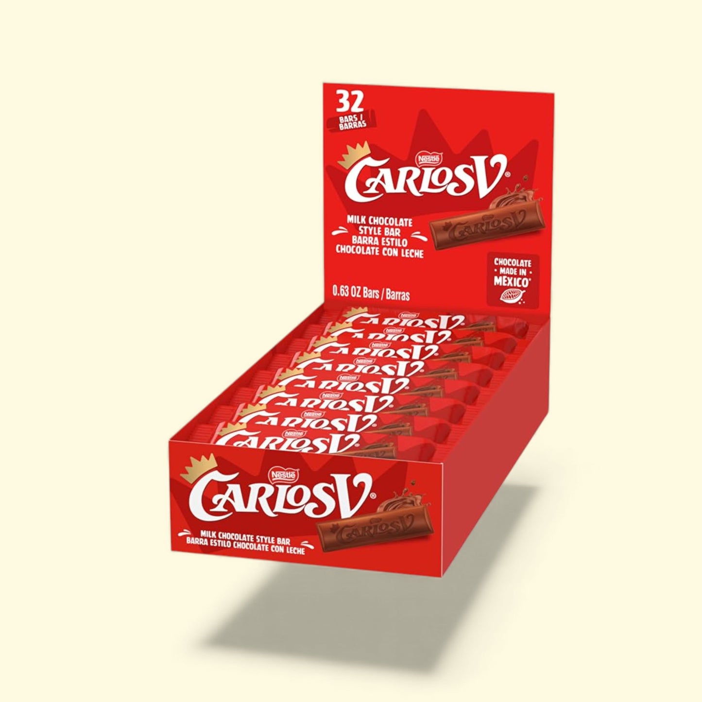 Box of Carlos V chocolate bars on a beige background