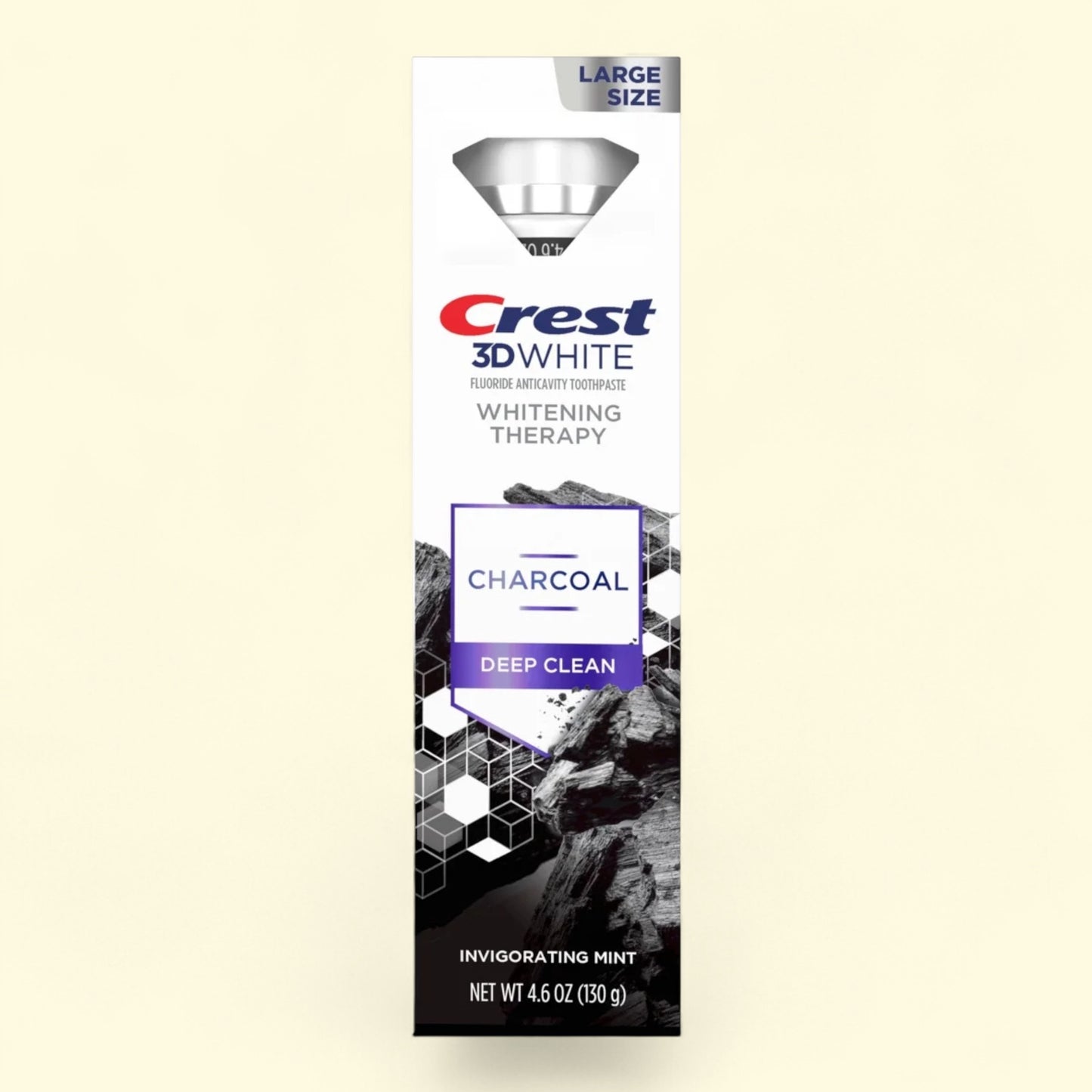 Crest 3D White Charcoal Deep Clean toothpaste packaging on a beige background
