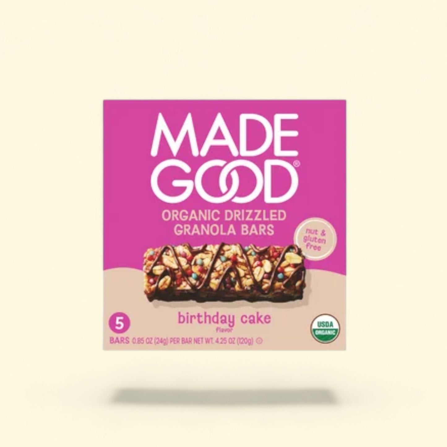Made Good organic drizzled granola bars with pink label on a beige background