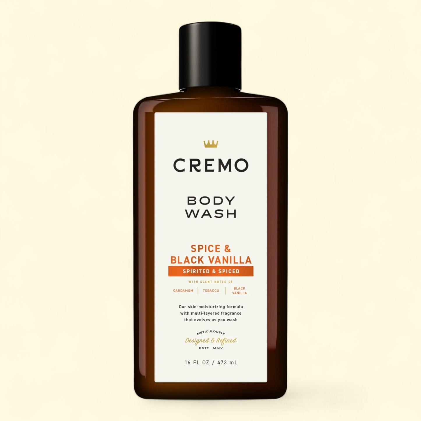 Cremo Spice & Black Vanilla body wash bottle on a beige background