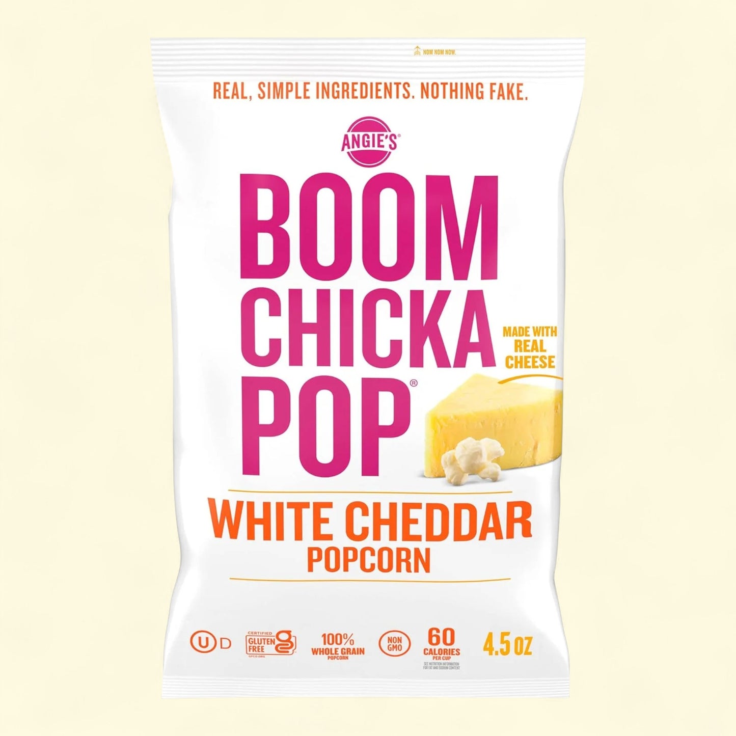 Angie's Boom Chicka Pop White Cheddar Popcorn packaging on a light yellow background