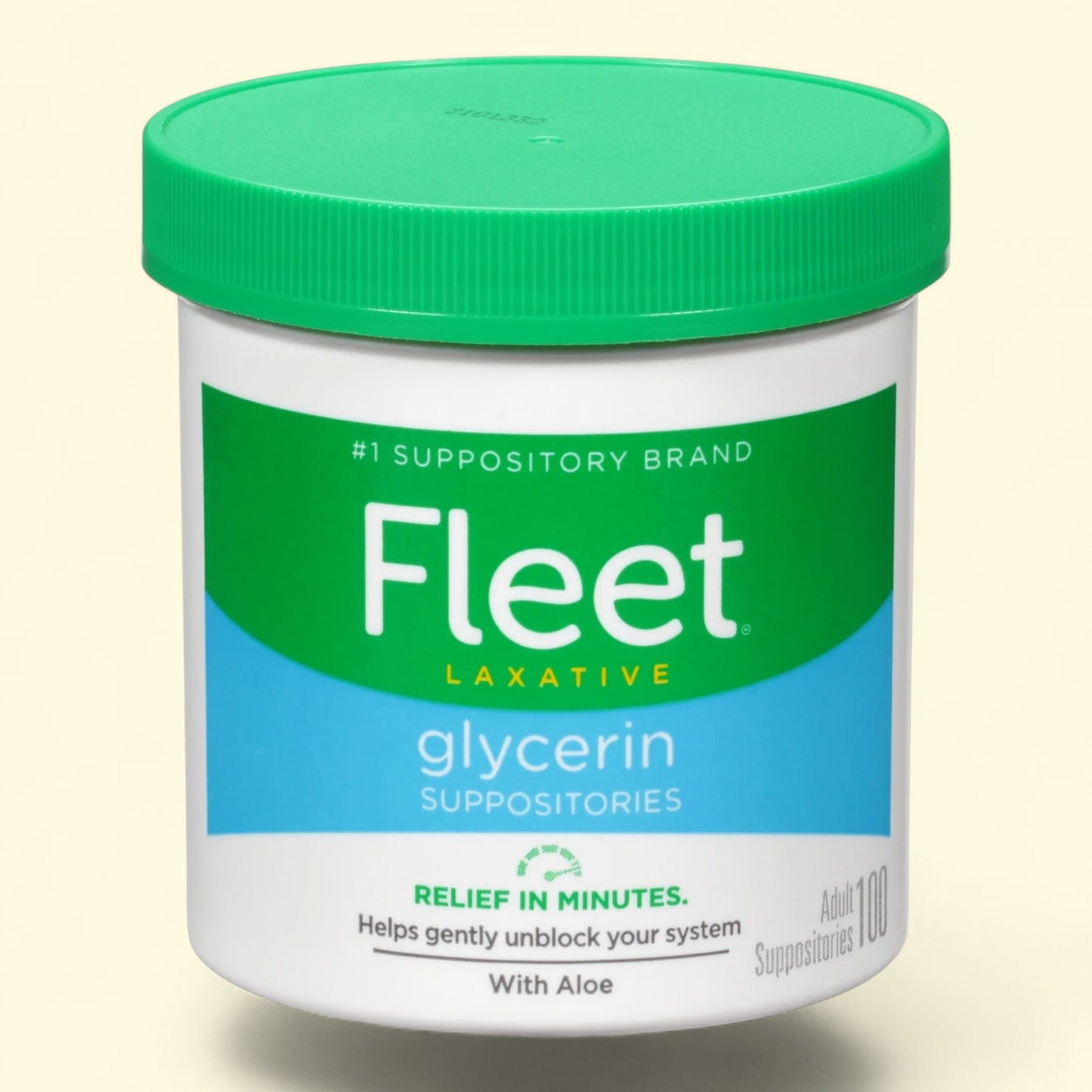 Fleet laxative glycerin suppositories container with green lid on a beige background