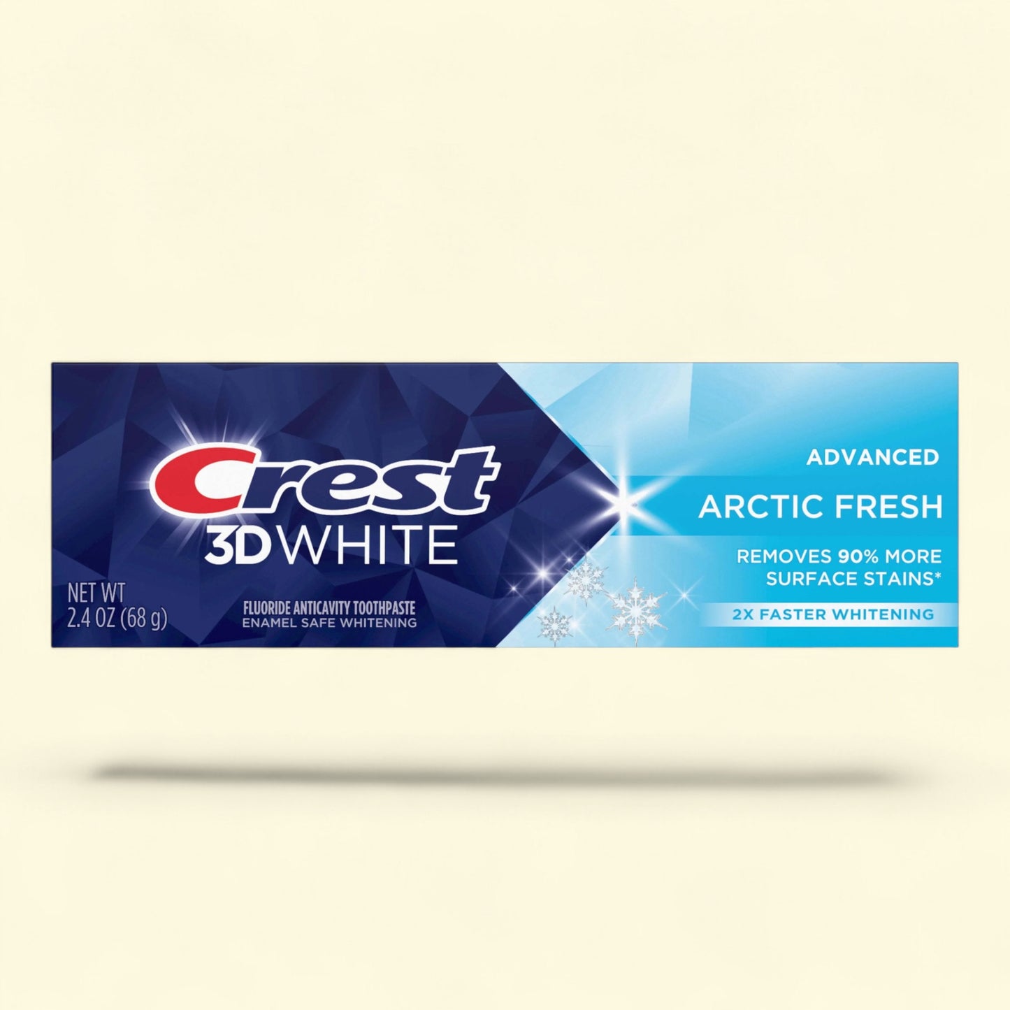 Crest 3D White toothpaste tube with Arctic Fresh flavor on a beige background