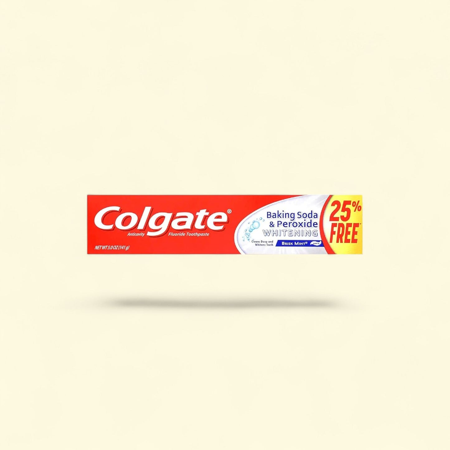 Colgate toothpaste tube on a beige background