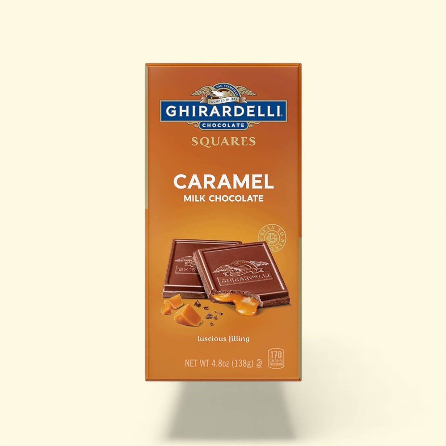 Ghirardelli Caramel Milk Chocolate Squares packaging on a beige background