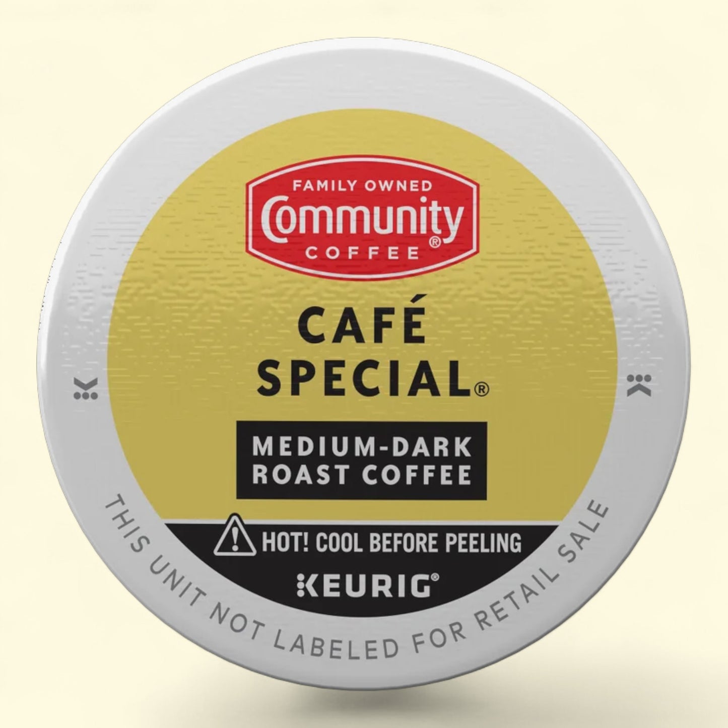 Keurig coffee pod with Community Coffee branding on a beige background