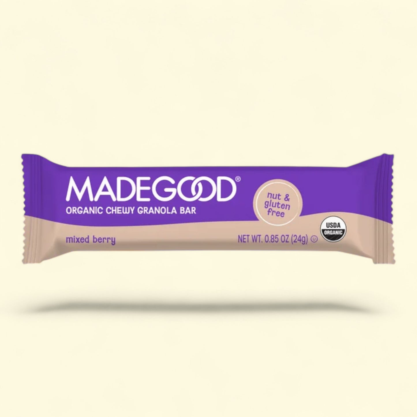Madegood organic cheery granola bar packaging on a beige background