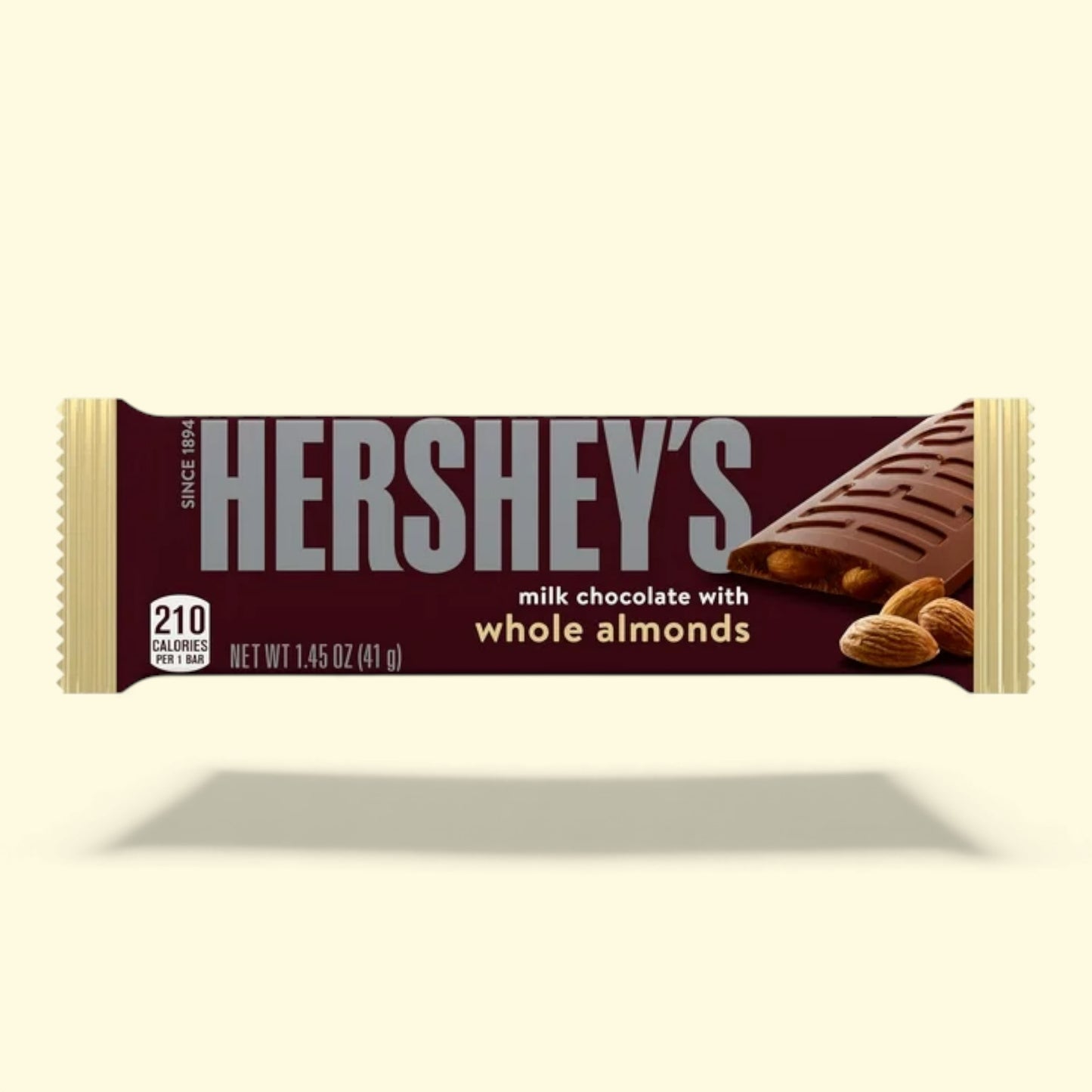 Hershey's milk chocolate bar with whole almonds on a beige background