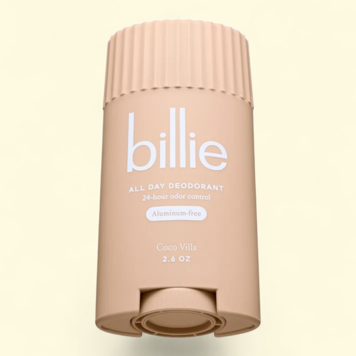 Beige deodorant stick with 'billie' branding on a light beige background