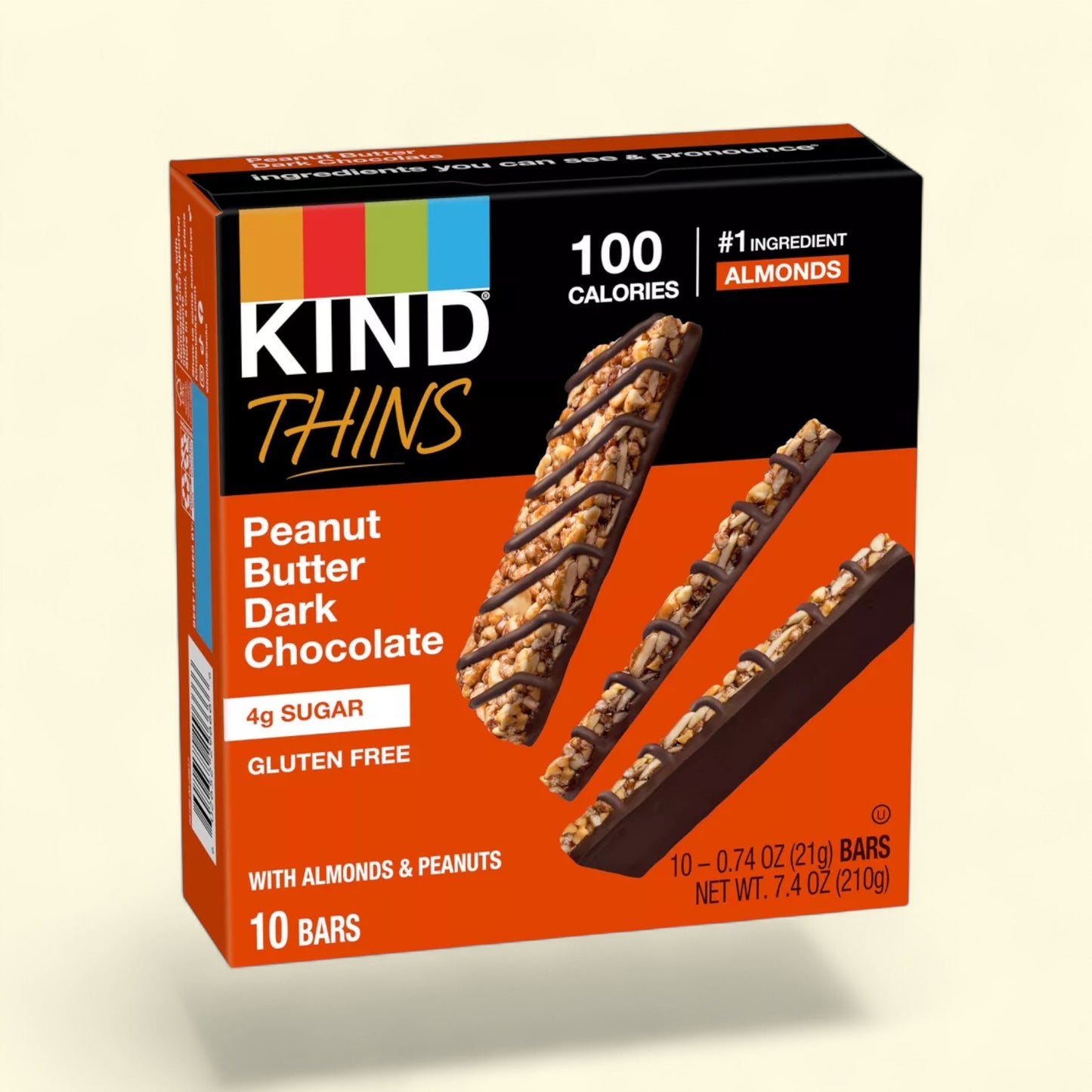 Kind Thins Peanut Butter Dark Chocolate bars on a beige background