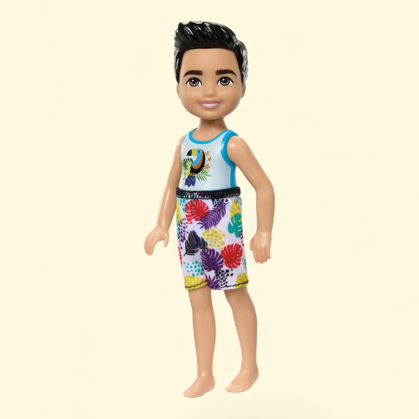 Barbie Chelsea Small Doll with Beach Swimsuit, Toucan & Tropical Leaf Print, Black Hair & Brown Eyes, 6 inches