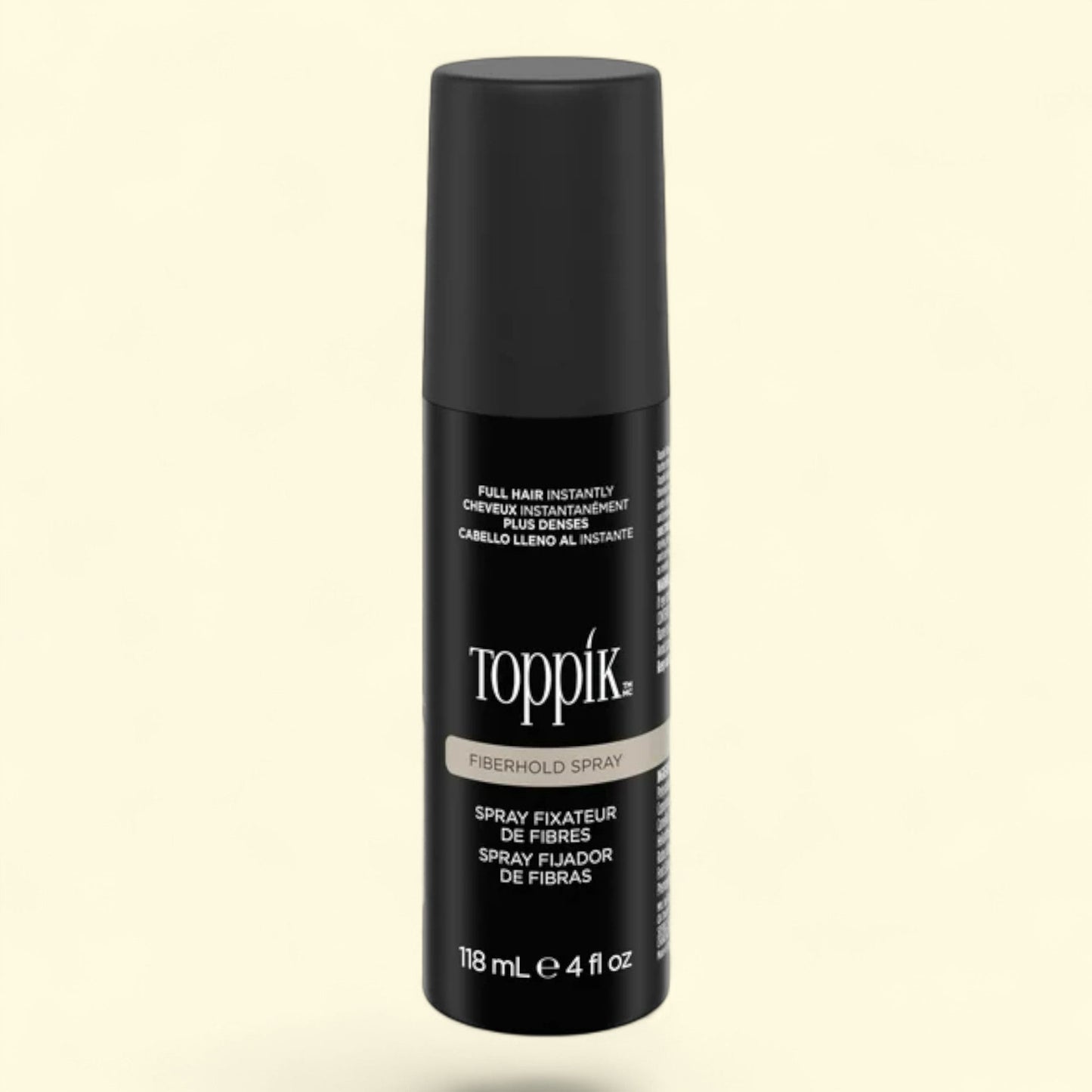 Toppik fiberhold spray bottle on a beige background