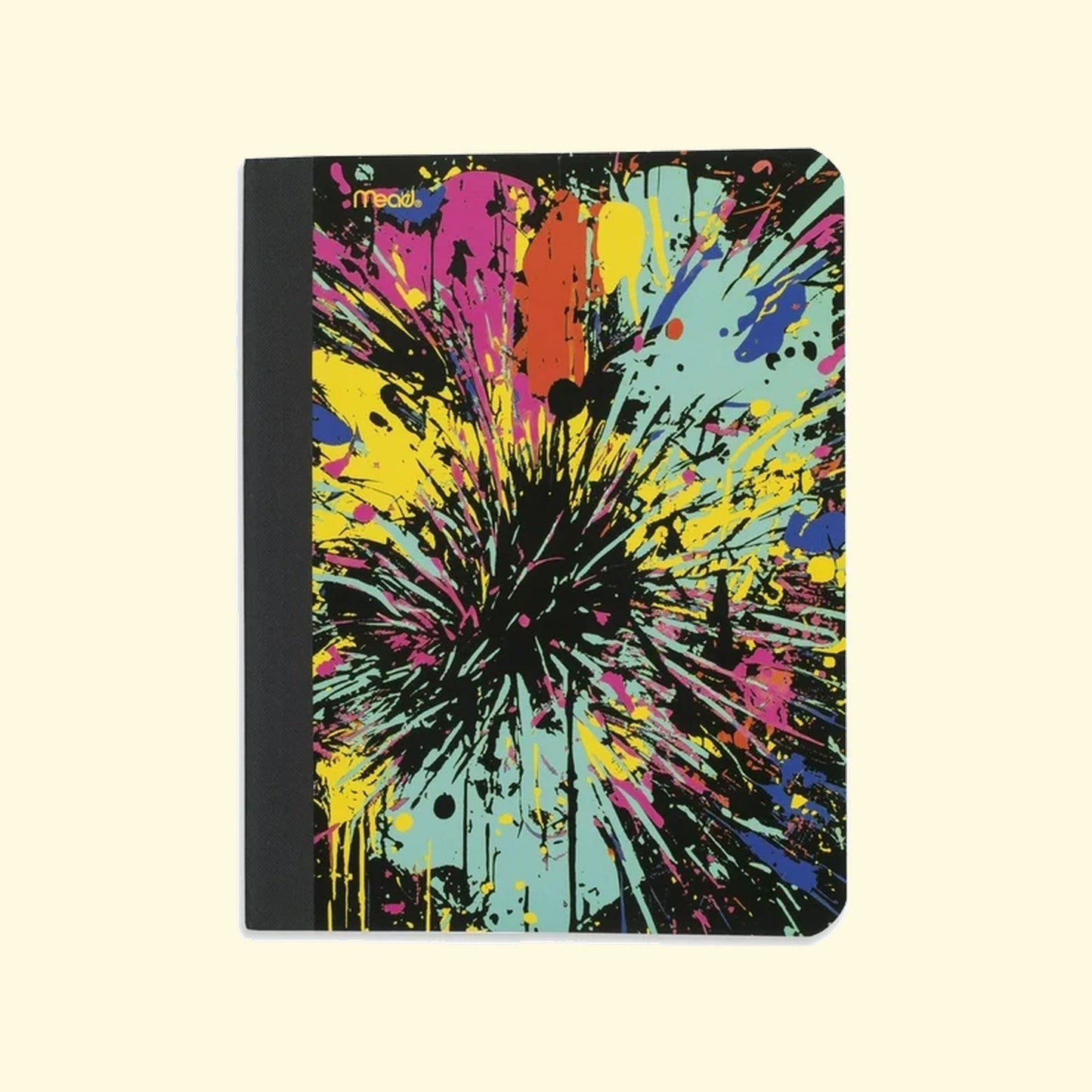 Notebook with colorful splatter design on a beige background