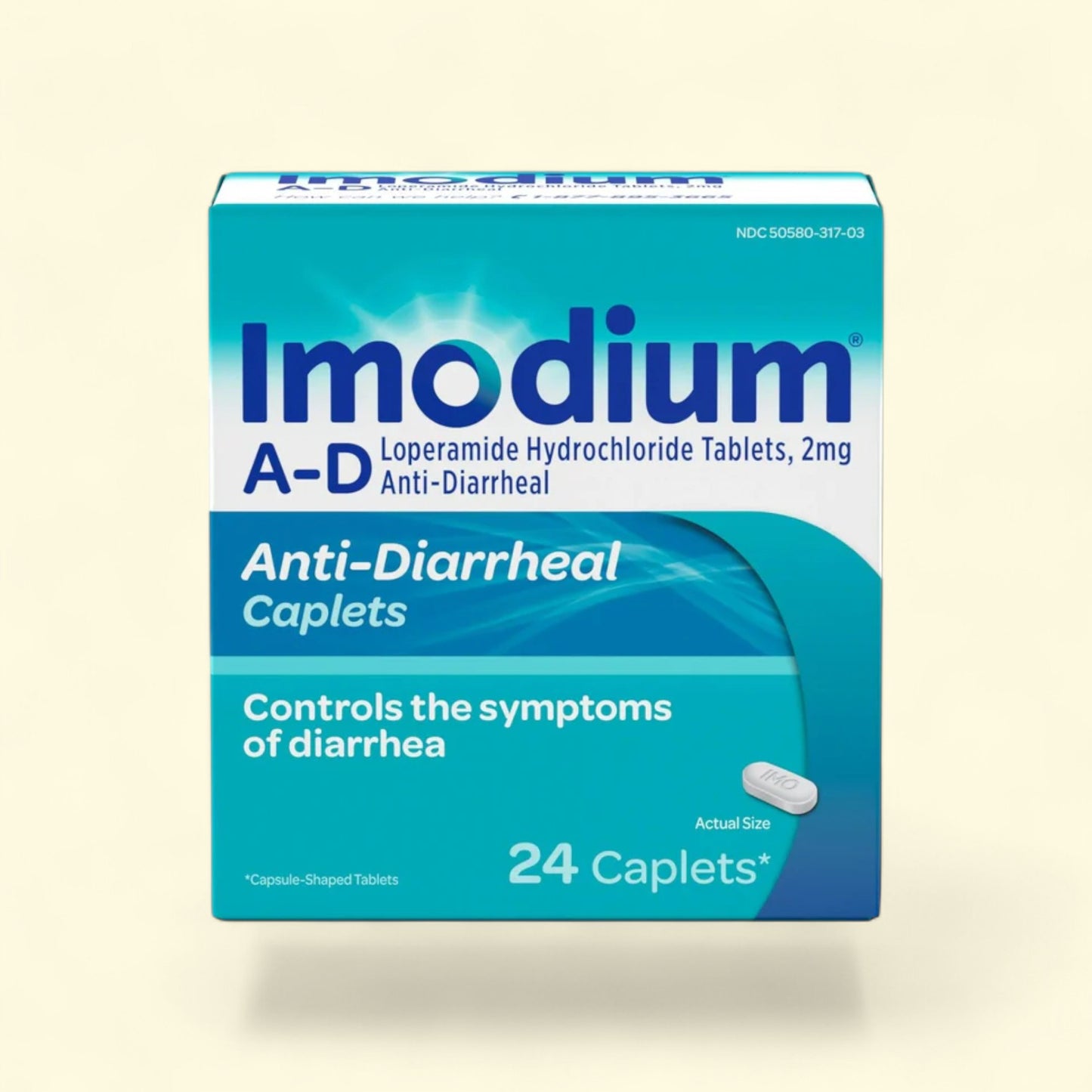 Imodium A-D anti-diarrheal caplets packaging on a beige background