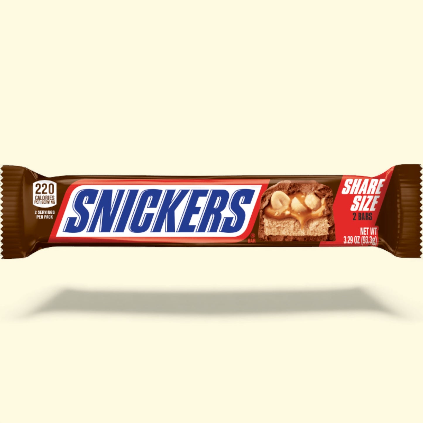 Snickers chocolate bar packaging on a beige background