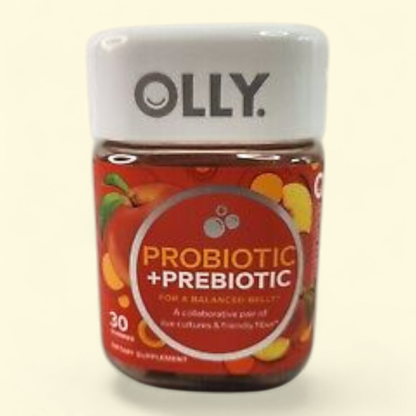 Olly probiotic and prebiotic supplement bottle on a beige background