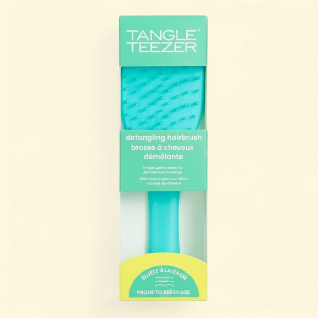 Treatspree Essential Detangler hairbrush in turquoise green, designed for hair prone to breakage.