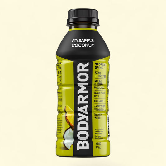 BodyArmor Pineapple Coconut sports drink bottle on a beige background