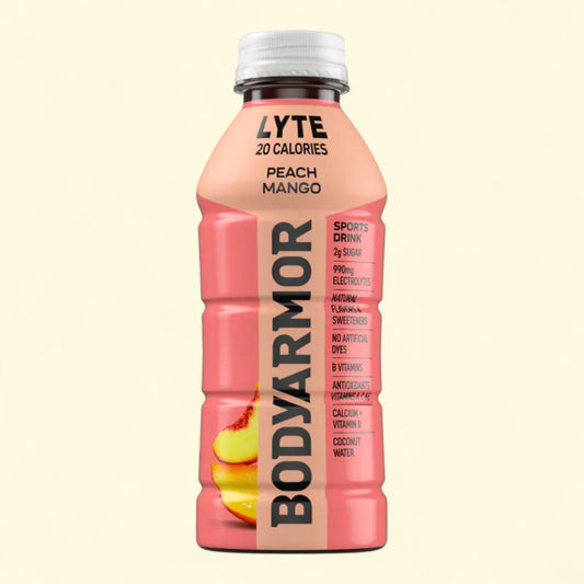 BodyArmor sports drink bottle with peach mango flavor on a beige background