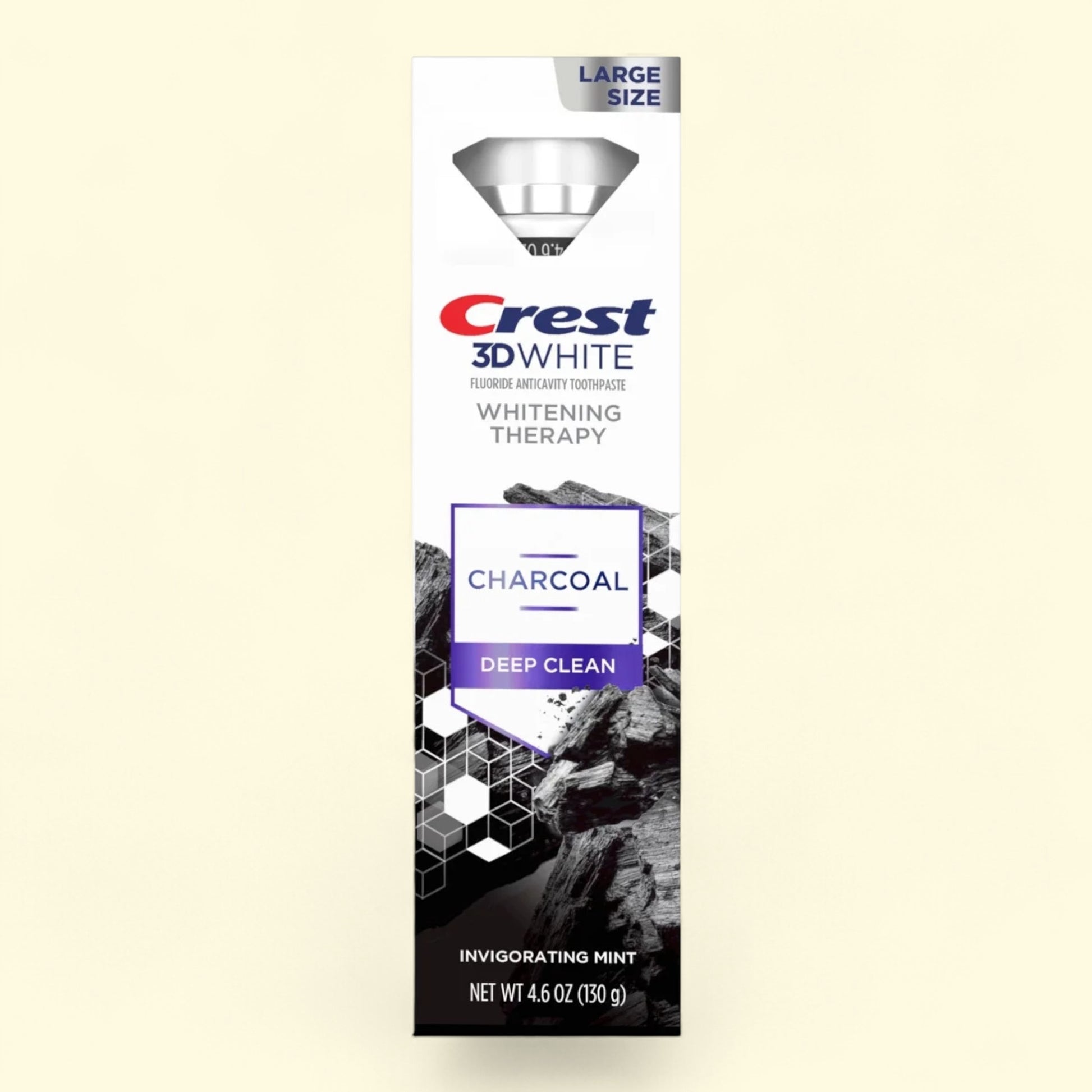 Crest 3D White Charcoal Deep Clean toothpaste packaging on a beige background