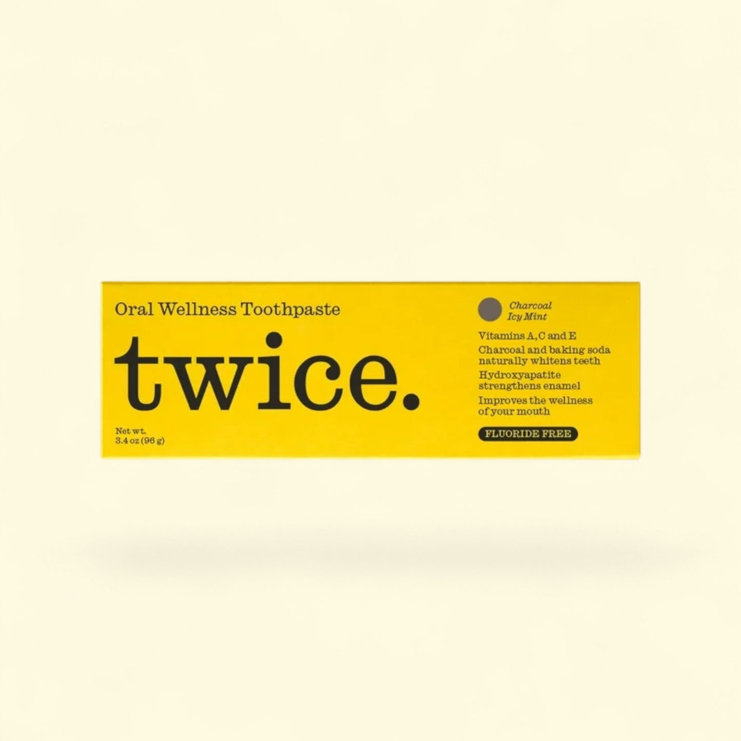 twice. Oral Wellness Toothpaste packaging on a beige background