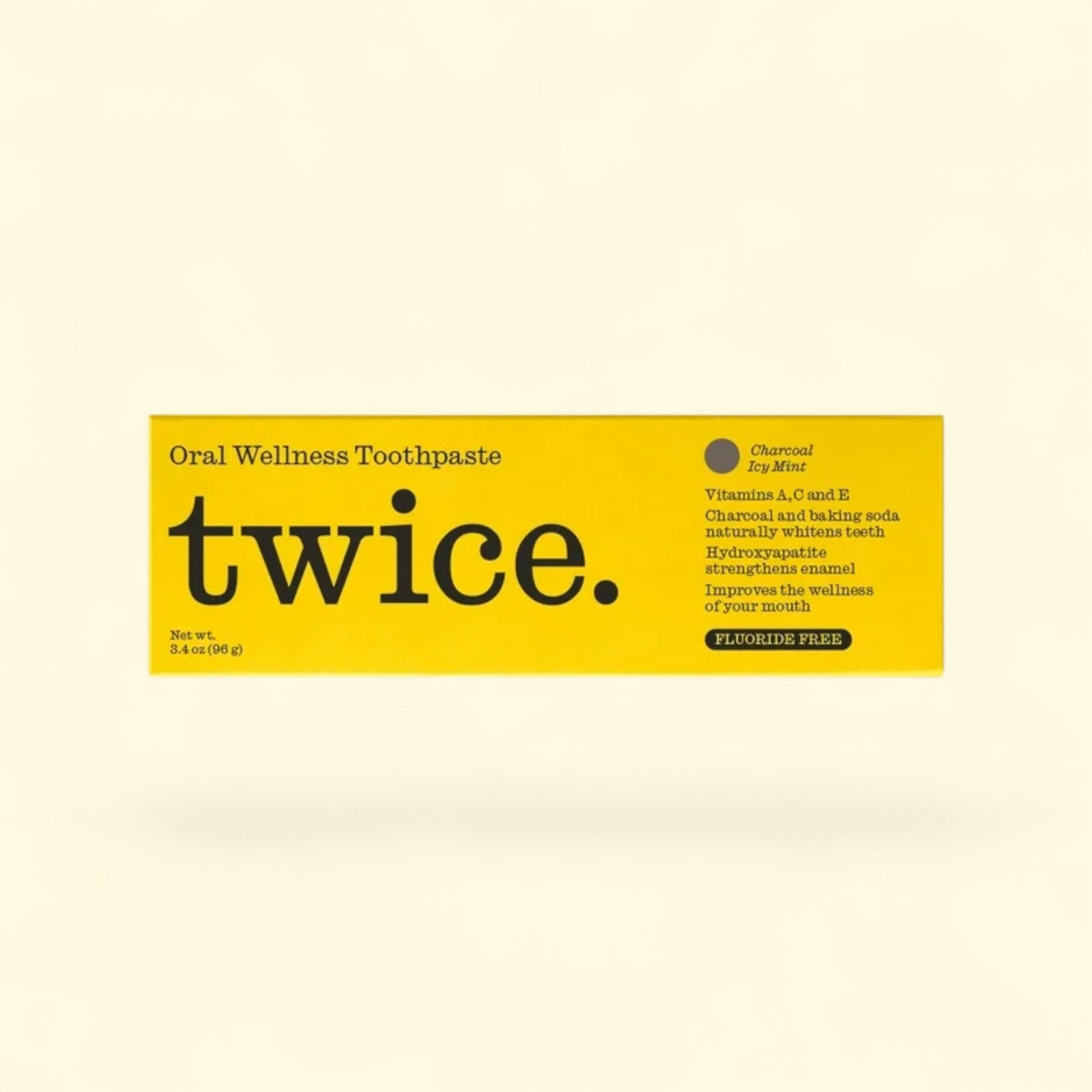 twice. Oral Wellness Toothpaste packaging on a beige background