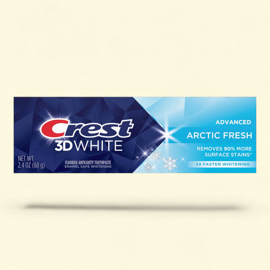 Crest 3D White toothpaste tube with Arctic Fresh flavor on a beige background