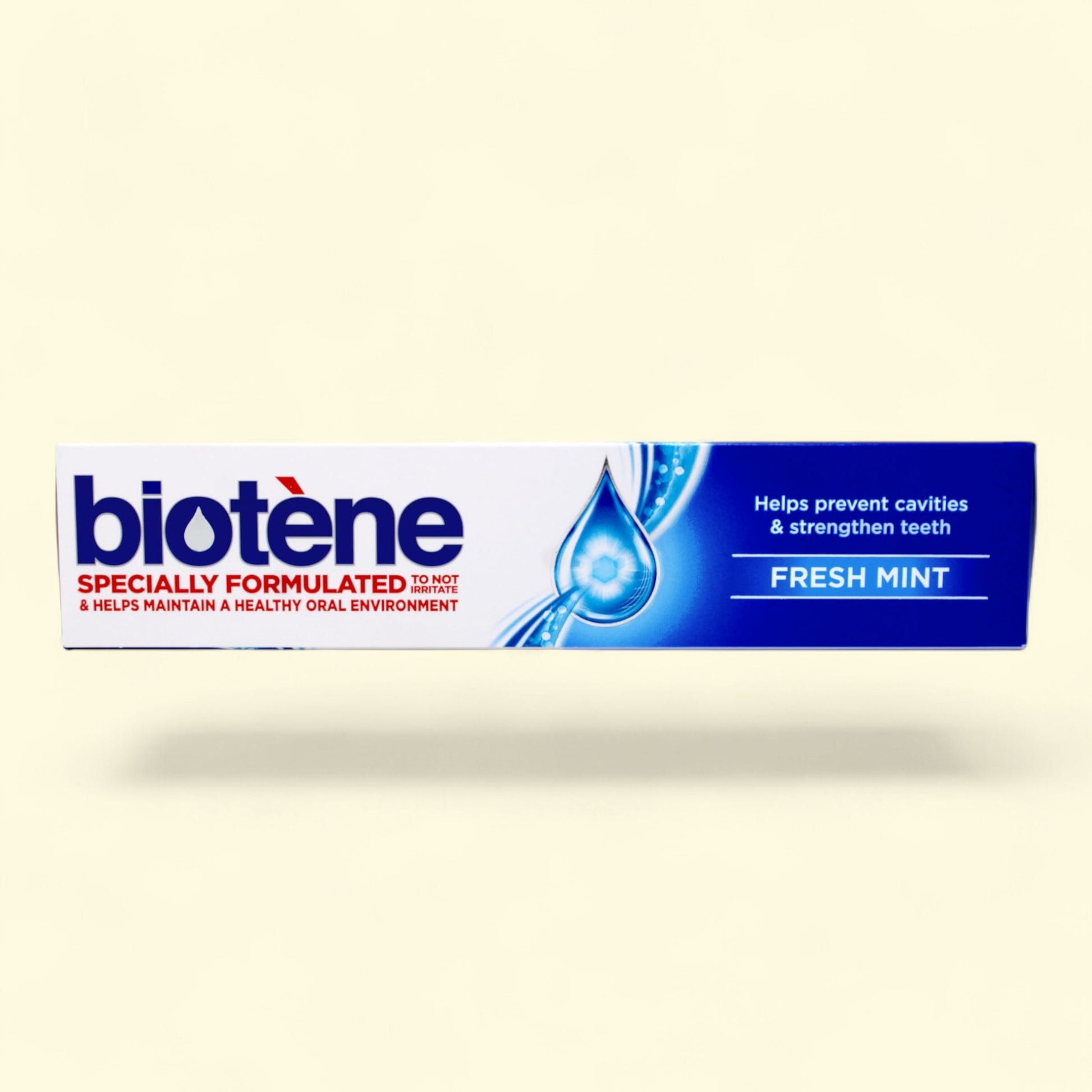 Biotene toothpaste tube on a beige background