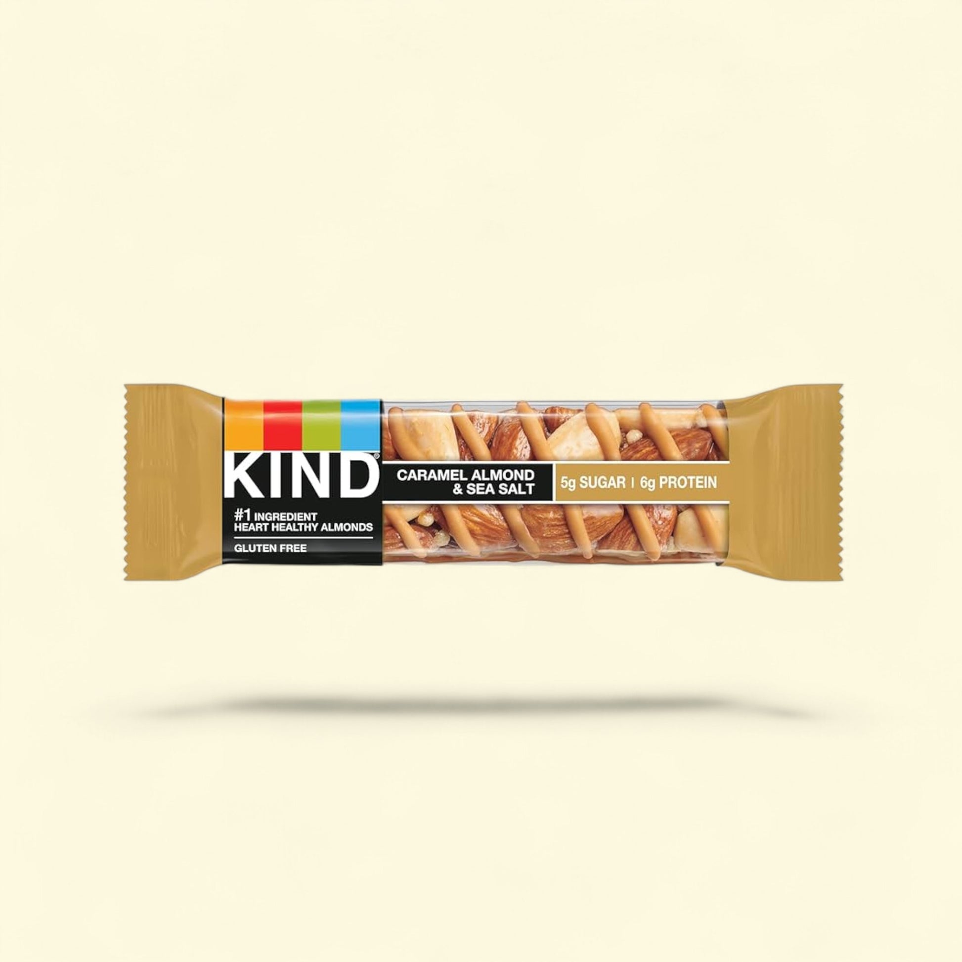 Kind Caramel Almond & Sea Salt bar packaging on a beige background