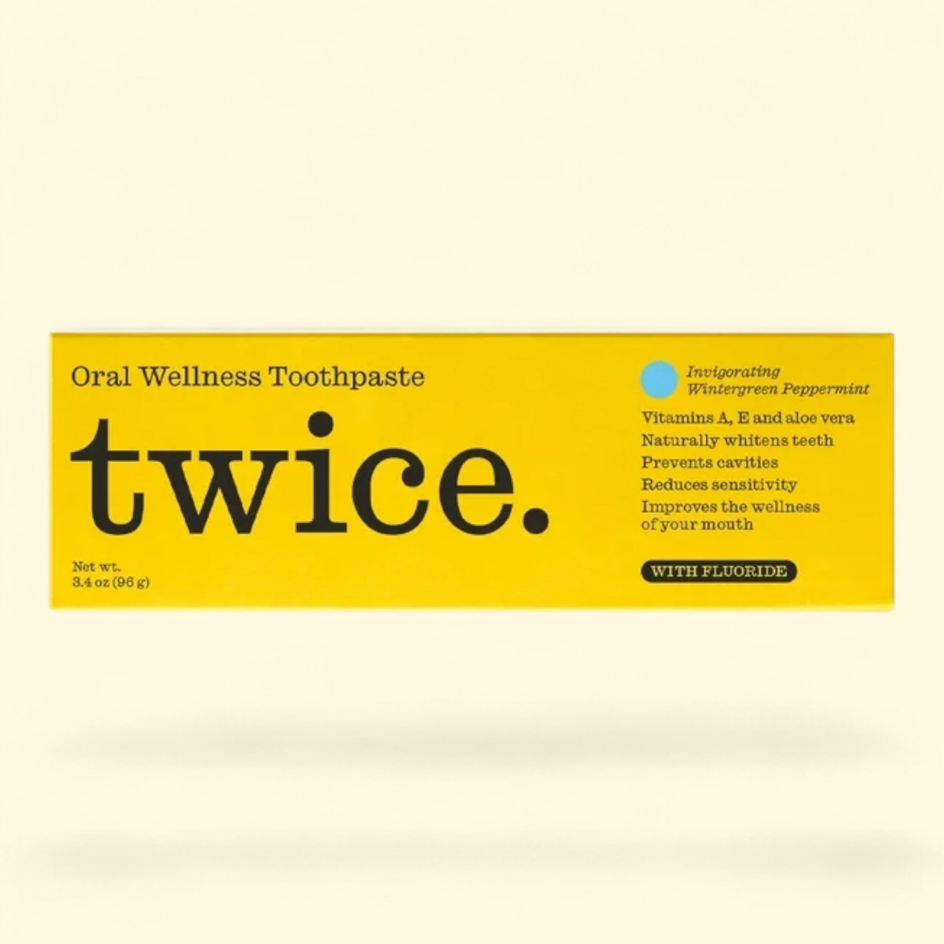 Twice oral wellness toothpaste packaging on a beige background