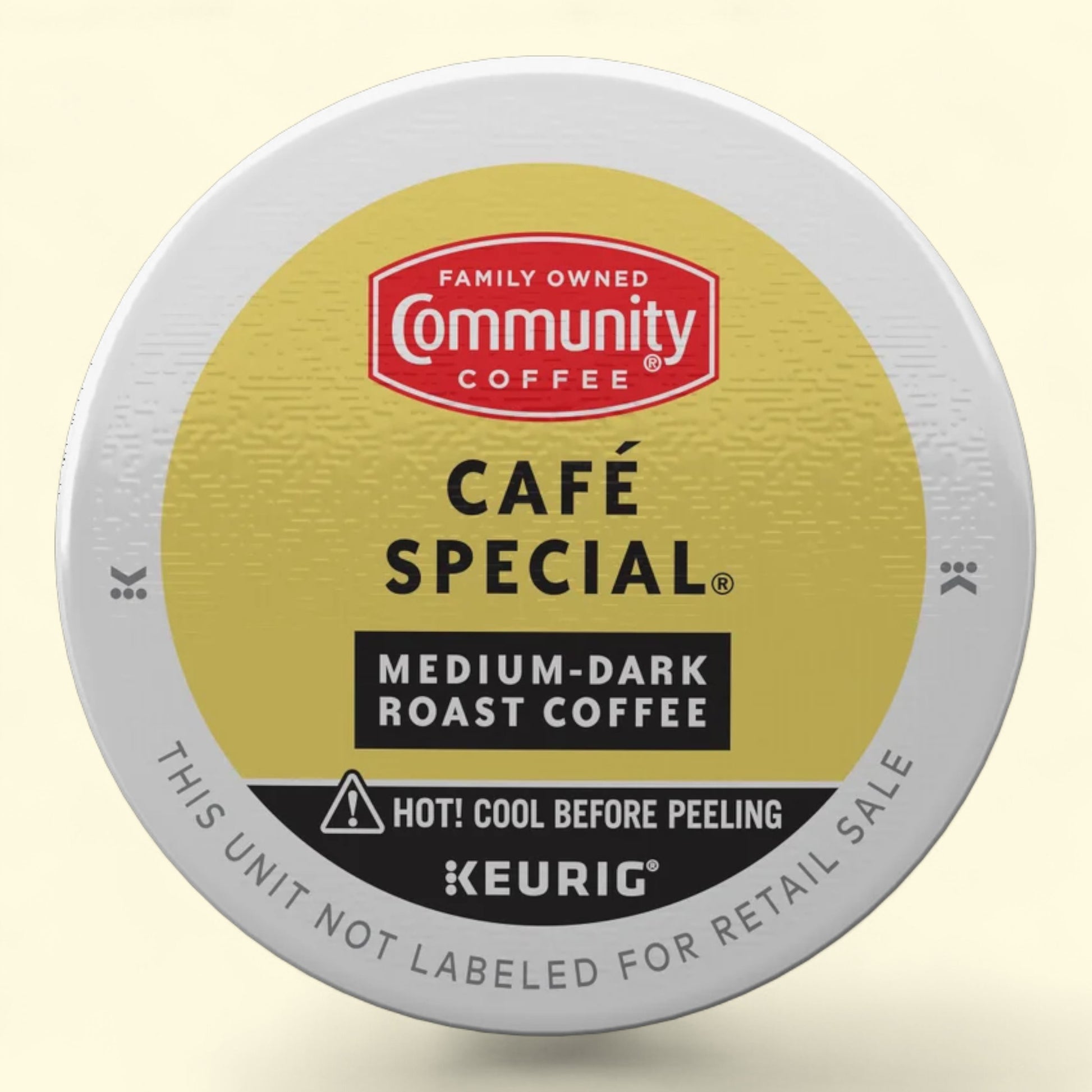 Keurig coffee pod with Community Coffee branding on a beige background