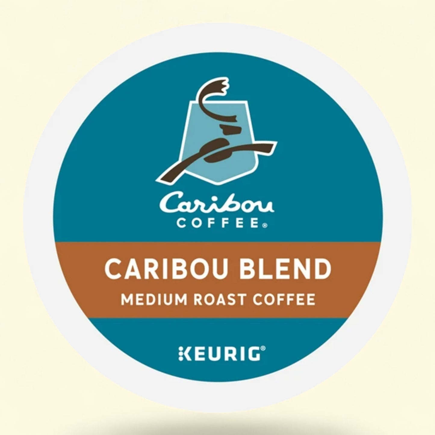 Caribou Coffee Caribou Blend medium roast Keurig coffee pod on a beige background
