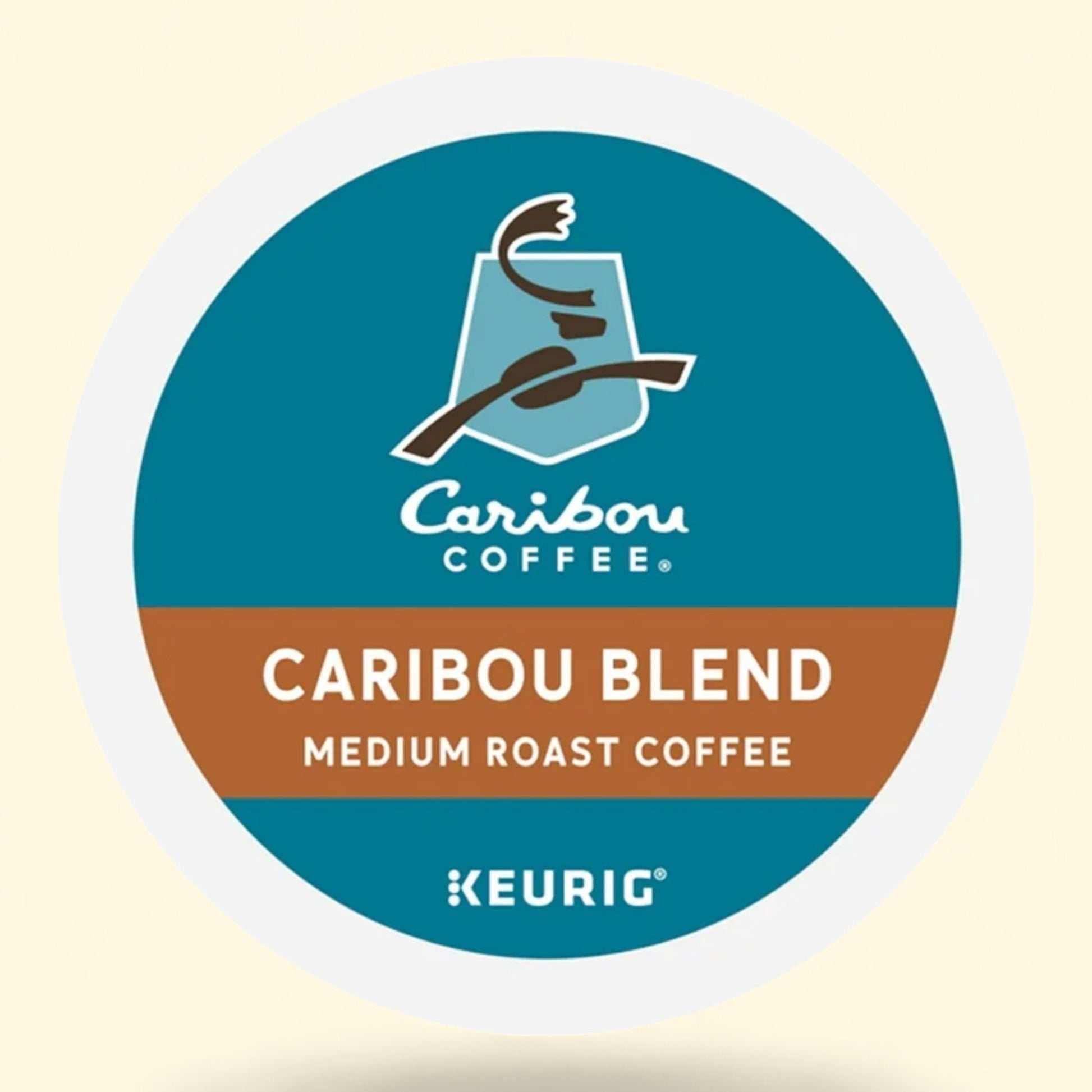 Caribou Coffee Caribou Blend medium roast Keurig coffee pod on a beige background
