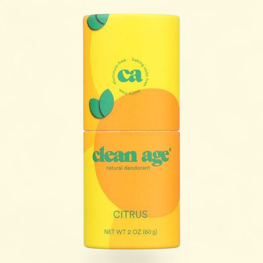 Yellow and orange deodorant container with 'clean age' branding on a beige background