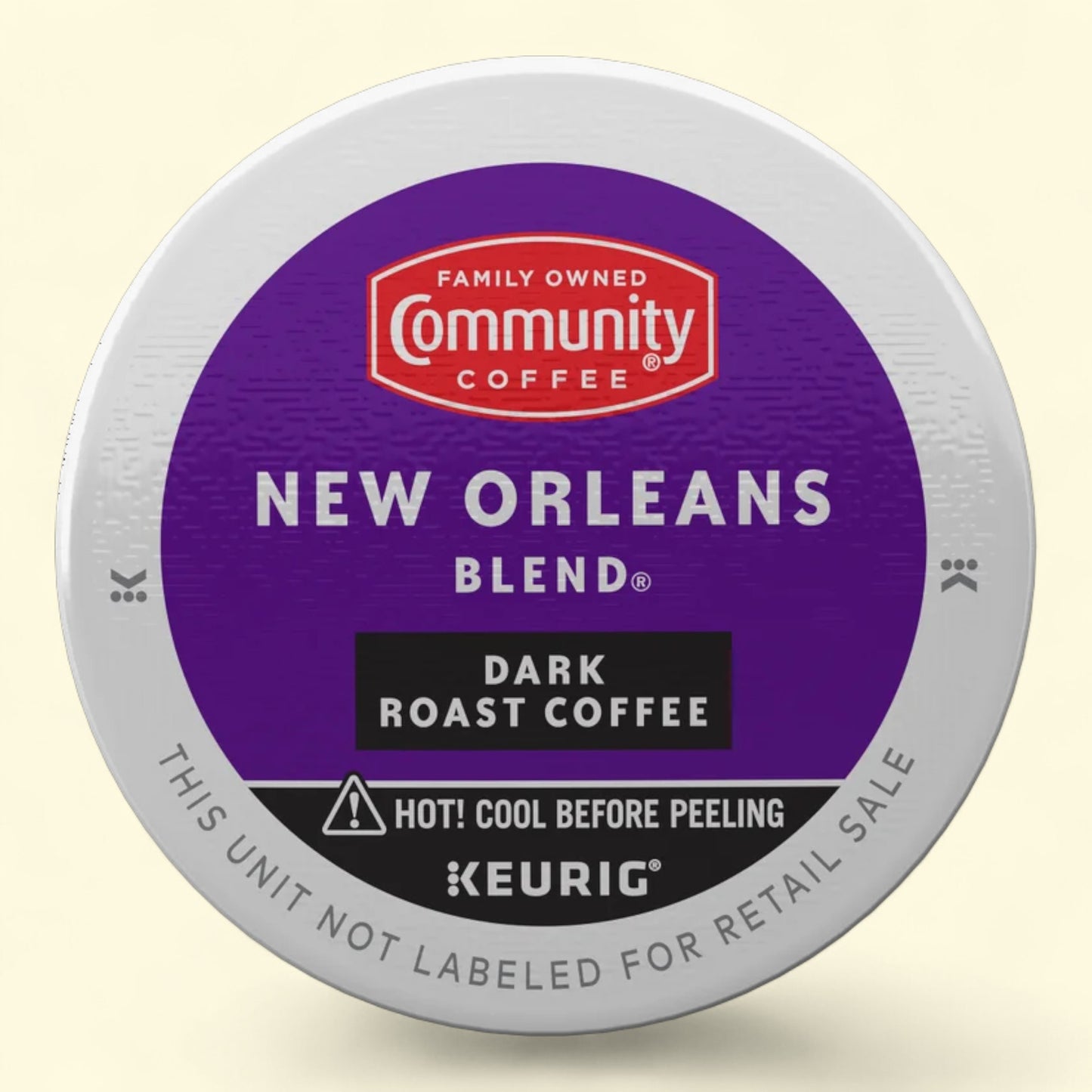 Keurig coffee pod with Community Coffee New Orleans Blend label on a beige background