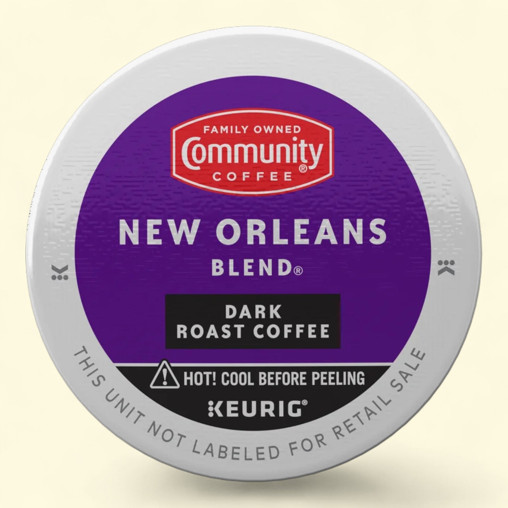 Keurig coffee pod with Community Coffee New Orleans Blend label on a beige background