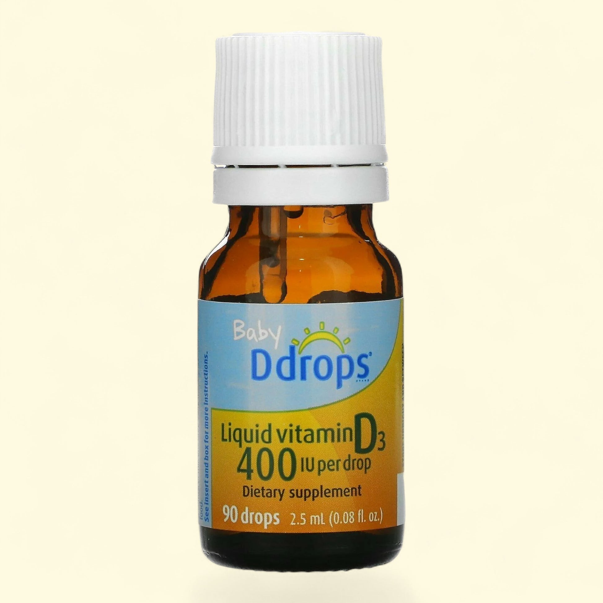 Baby Ddrops liquid vitamin D3 supplement bottle on a beige background