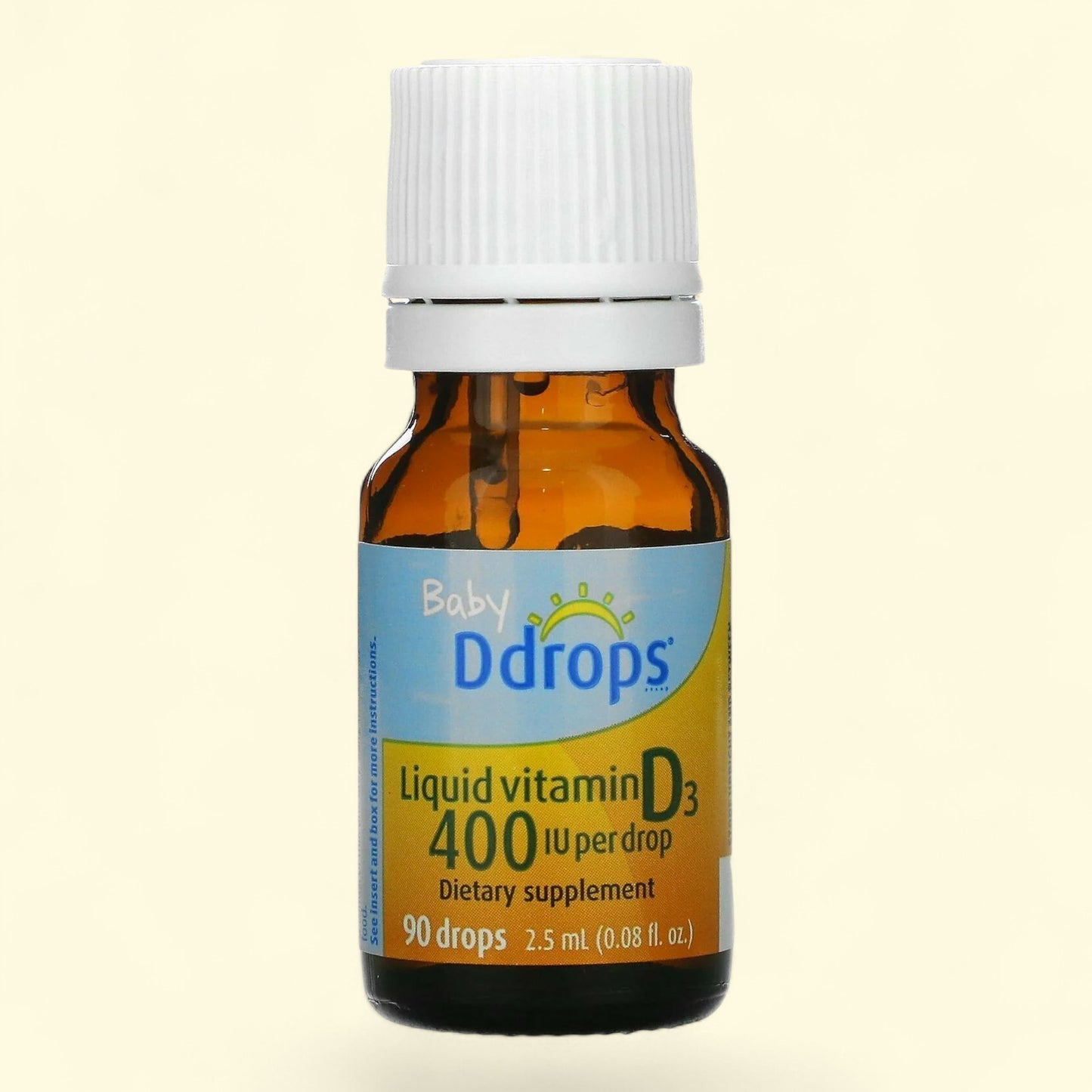 Baby Ddrops liquid vitamin D3 bottle on a beige background