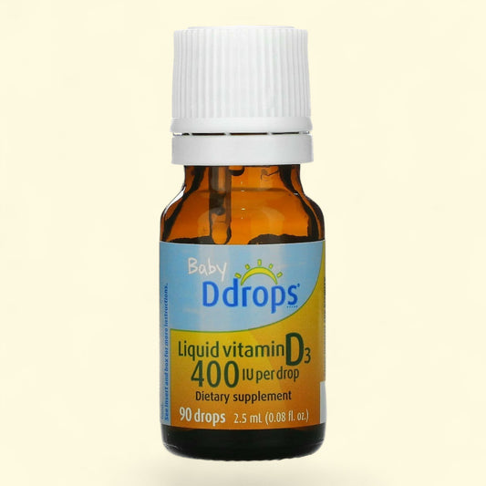 Baby Ddrops liquid vitamin D3 bottle on a beige background