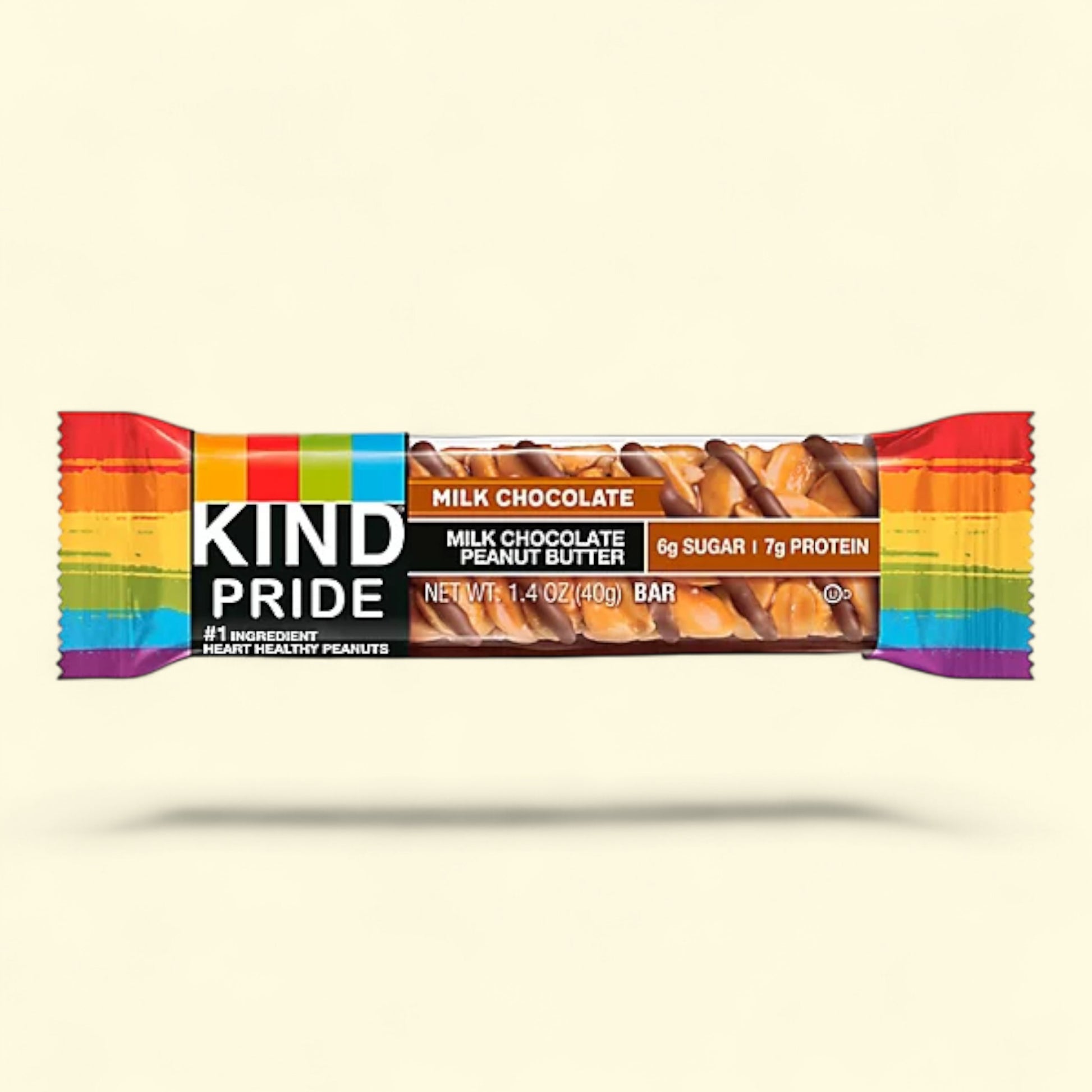 Kind Pride milk chocolate peanut butter bar with rainbow wrapper on a beige background