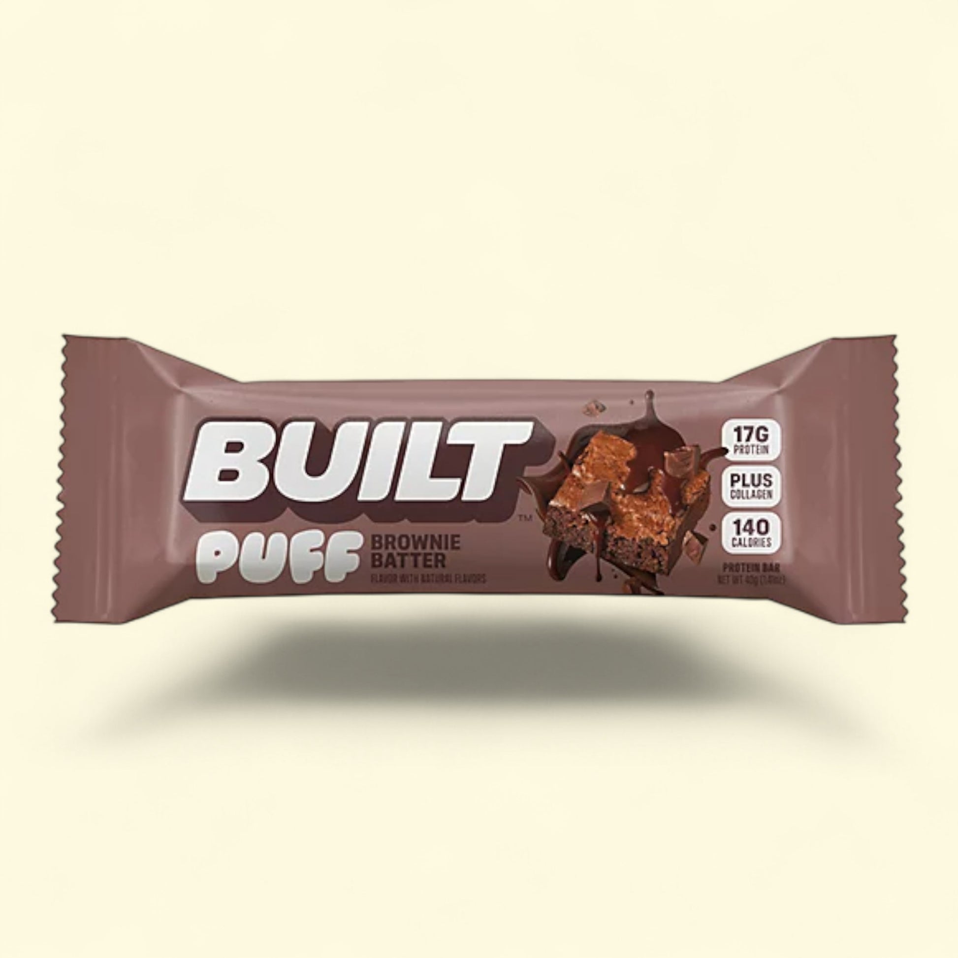 Built Puff Brownie Batter protein bar packaging on a beige background