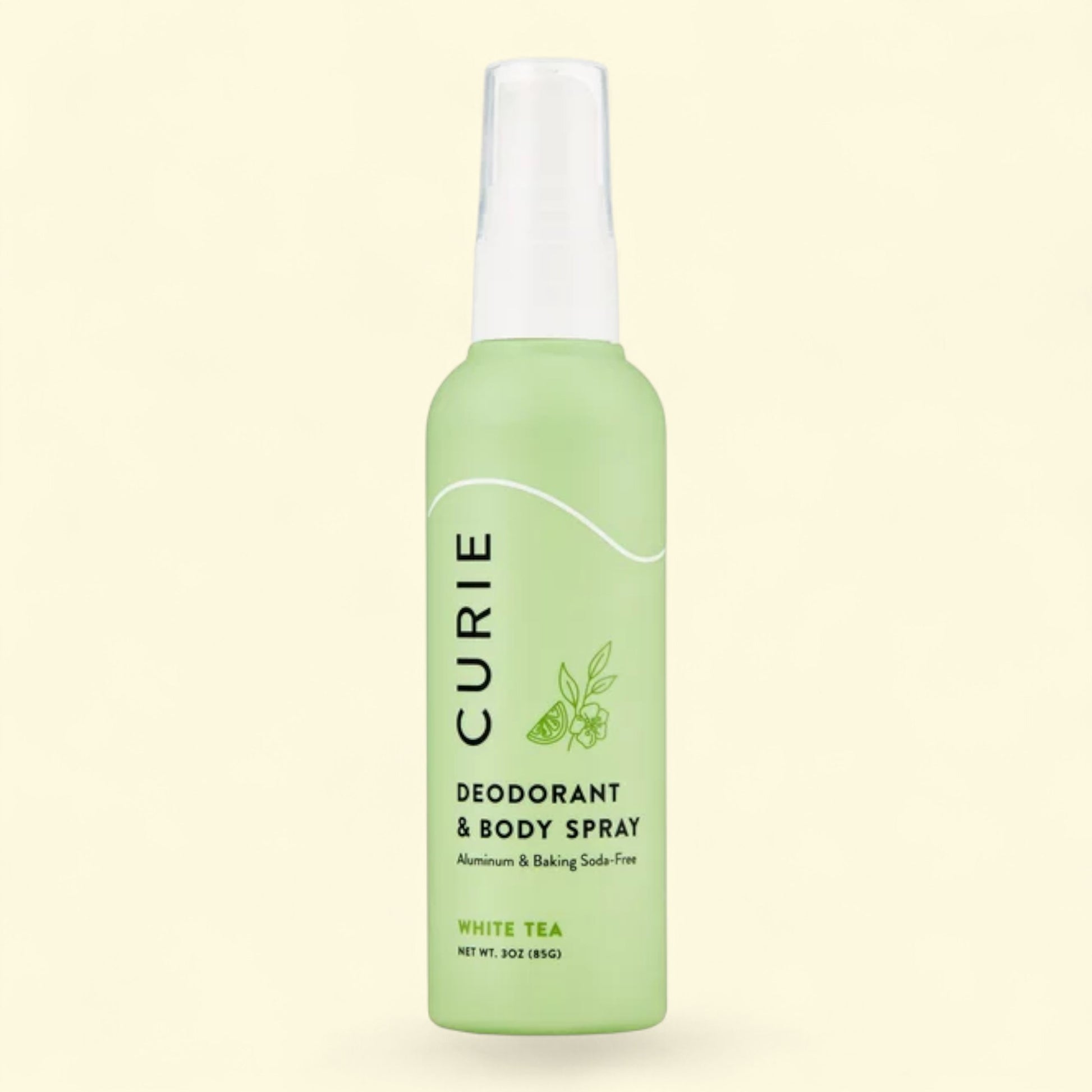 Green Curie deodorant and body spray bottle on a light beige background