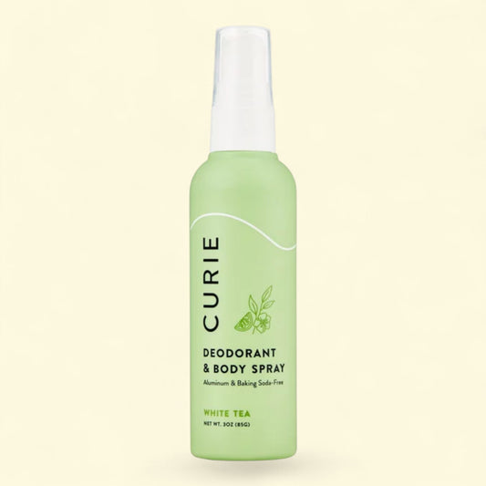Green Curie deodorant and body spray bottle on a light beige background