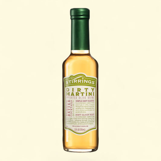 Bottle of Stirrings Dirty Martini mixer on a beige background