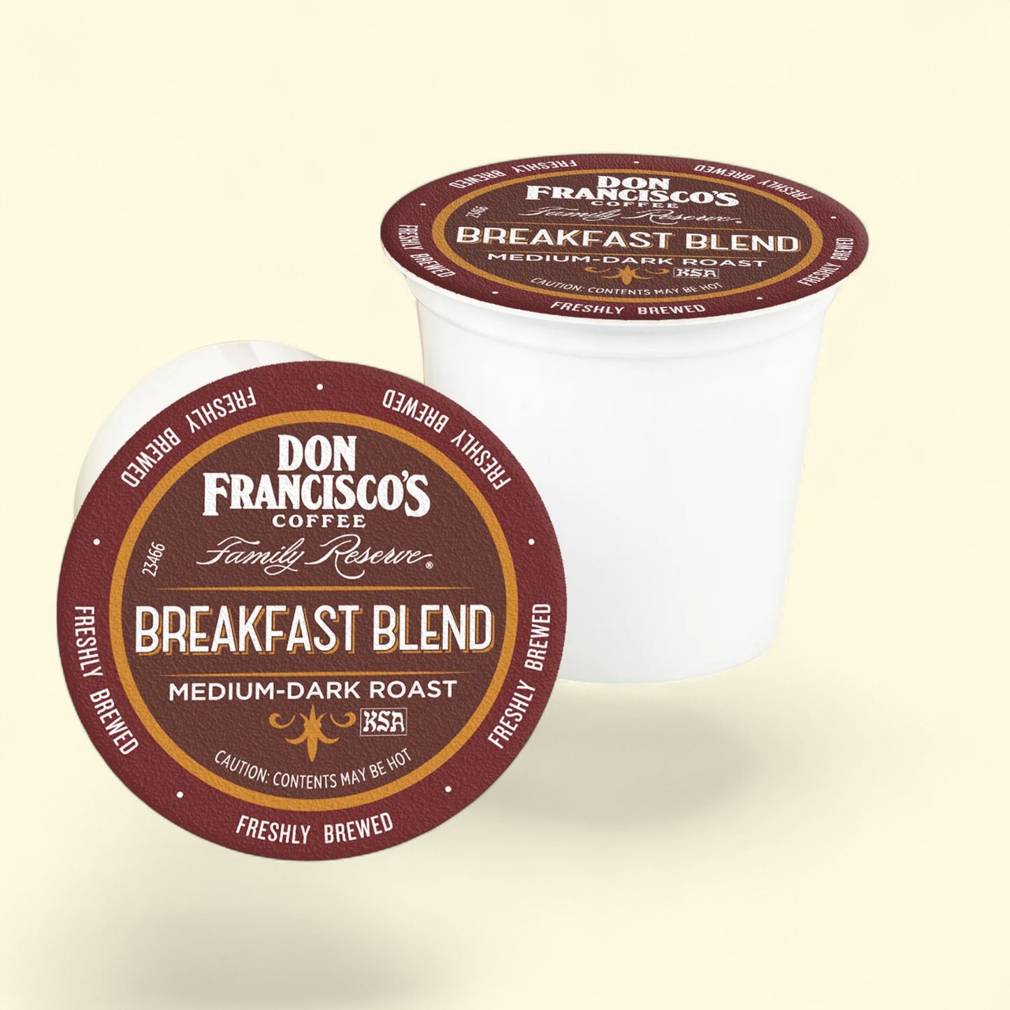Two Don Francisco's Coffee Family Reserve Breakfast Blend coffee pods on a beige background