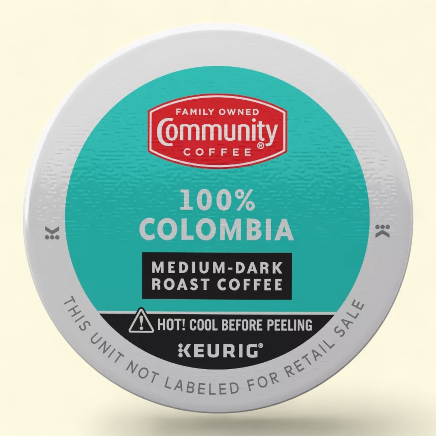 Keurig medium dark roast coffee with Community Coffee 100% colombia branding on a light beige background