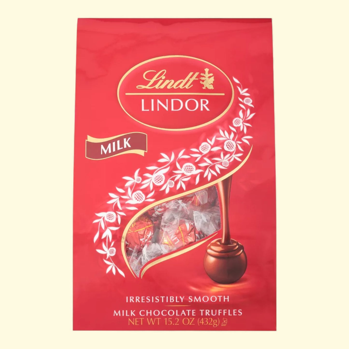 Lindt Lindor milk chocolate truffles packaging on a beige background