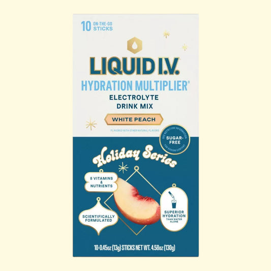 Liquid I.V. White Peach flavor electrolyte drink mix packaging on a light blue background