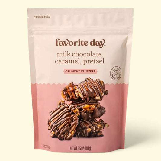 Package of Favorite Day milk chocolate, caramel, pretzel crunchy clusters on a beige background