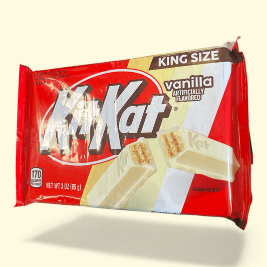 King size vanilla Kit Kat candy bar packaging on a beige background